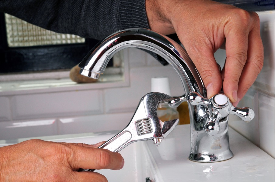 Plumbing repairing a sink faucet at a house in Batavia, Illinois